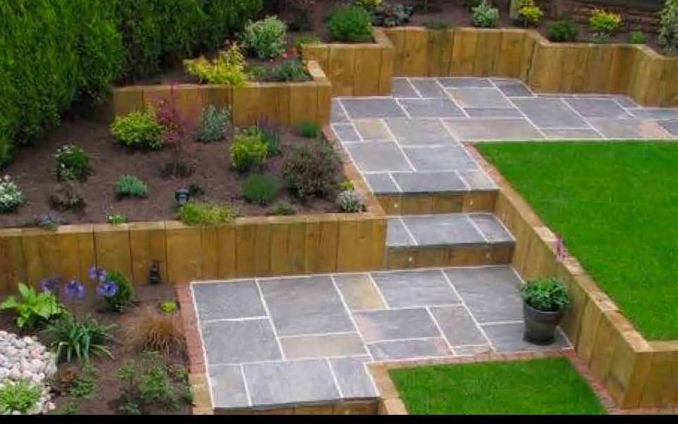 Terraced patio with oak sleepers, stone paving and new lawn